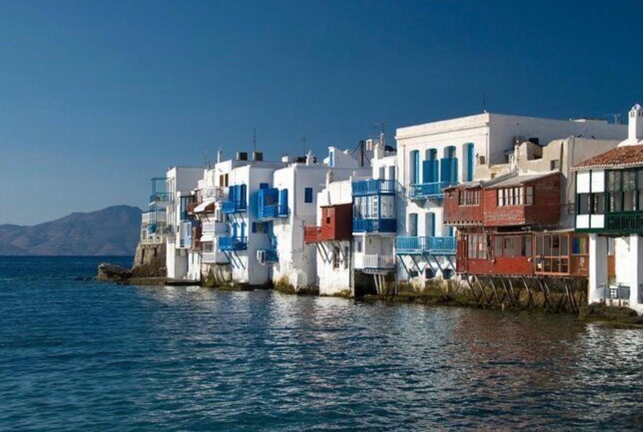 The colourful waterfront houses of Little Venice above the Mykonos sea